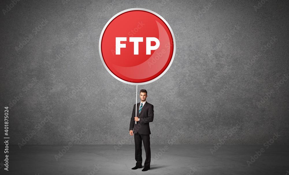Obraz premium Young business person holdig traffic sign with FTP abbreviation, technology solution concept