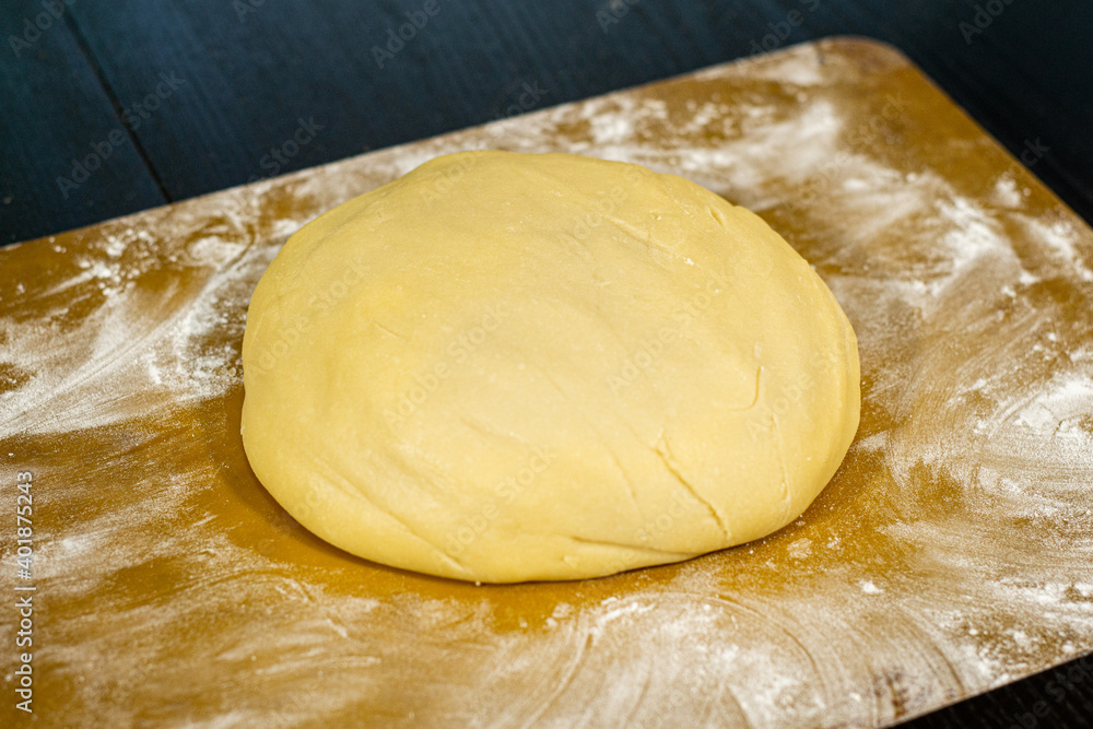 Ready dough on a black table and a silicone mat Ready dough on a black table and a silicone mat