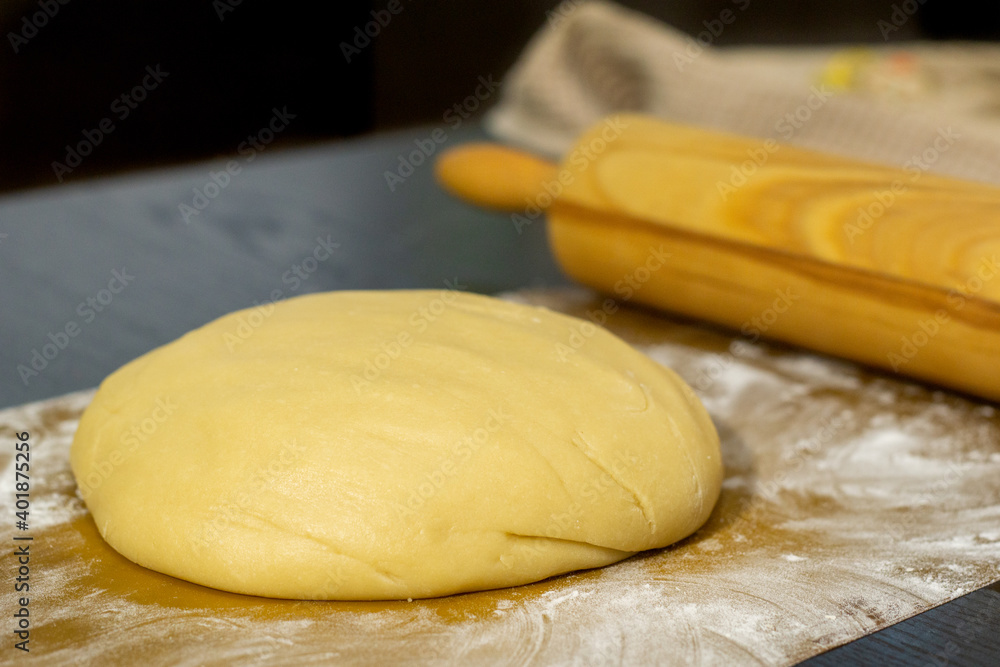 Ready dough on a black table and a silicone mat Ready dough on a black table and a silicone mat