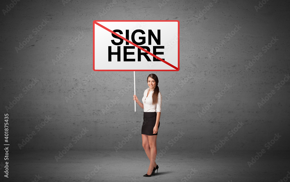 business person holding a traffic sign with SIGN HERE inscription, new idea concept business person holding a traffic sign with SIGN HERE inscription, new idea concept