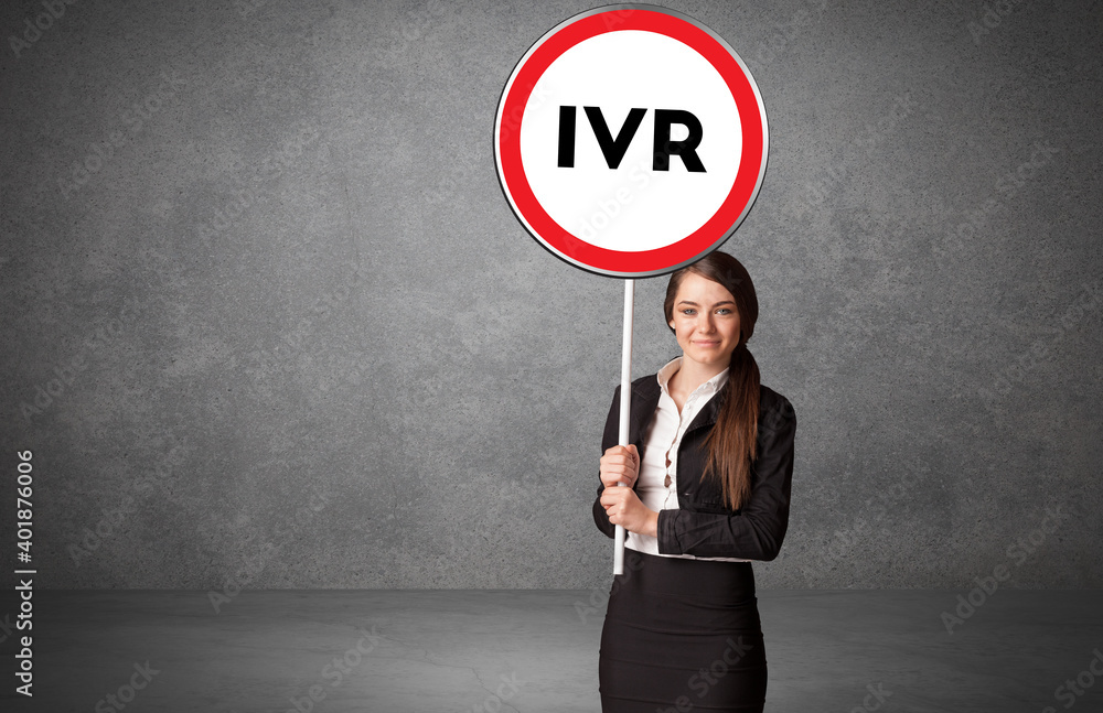 Young business person holdig traffic sign with IVR abbreviation, technology solution concept Young business person holdig traffic sign with IVR abbreviation, technology solution concept