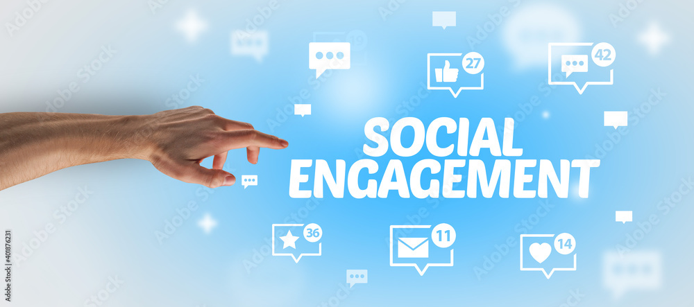 Close-Up of cropped hand pointing at SOCIAL ENGAGEMENT inscription, social networking concept Close-Up of cropped hand pointing at SOCIAL ENGAGEMENT inscription, social networking concept