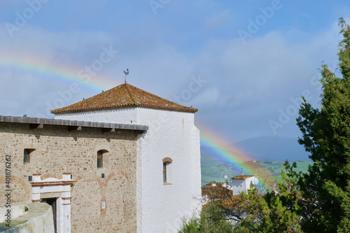rainbow behind a tower