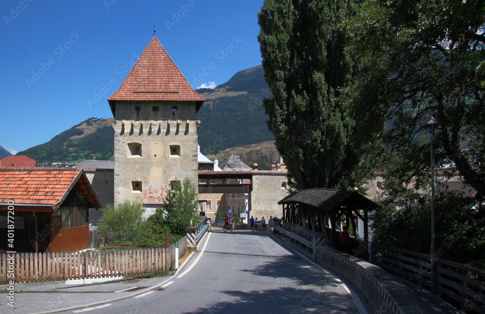 Medieval Tauferer Tor city gate with a covered bridge in the old town of Glurns in Vinschgau region, South Tyrol in Italy