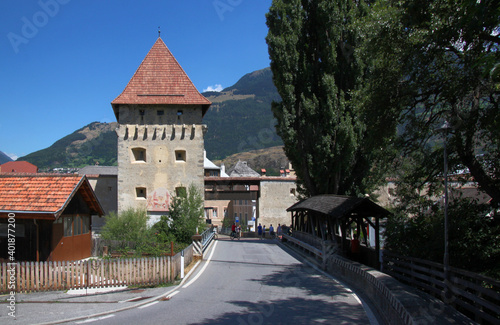 Medieval Tauferer Tor city gate with a covered bridge in the old town of Glurns in Vinschgau region, South Tyrol in Italy