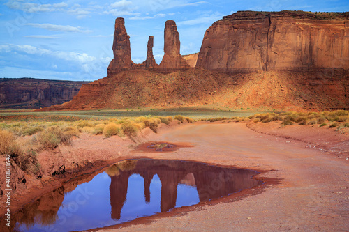 Roadside puddle reflects formations  along the Loop Road in Monument Valley Tribal Park of northern Arizona.