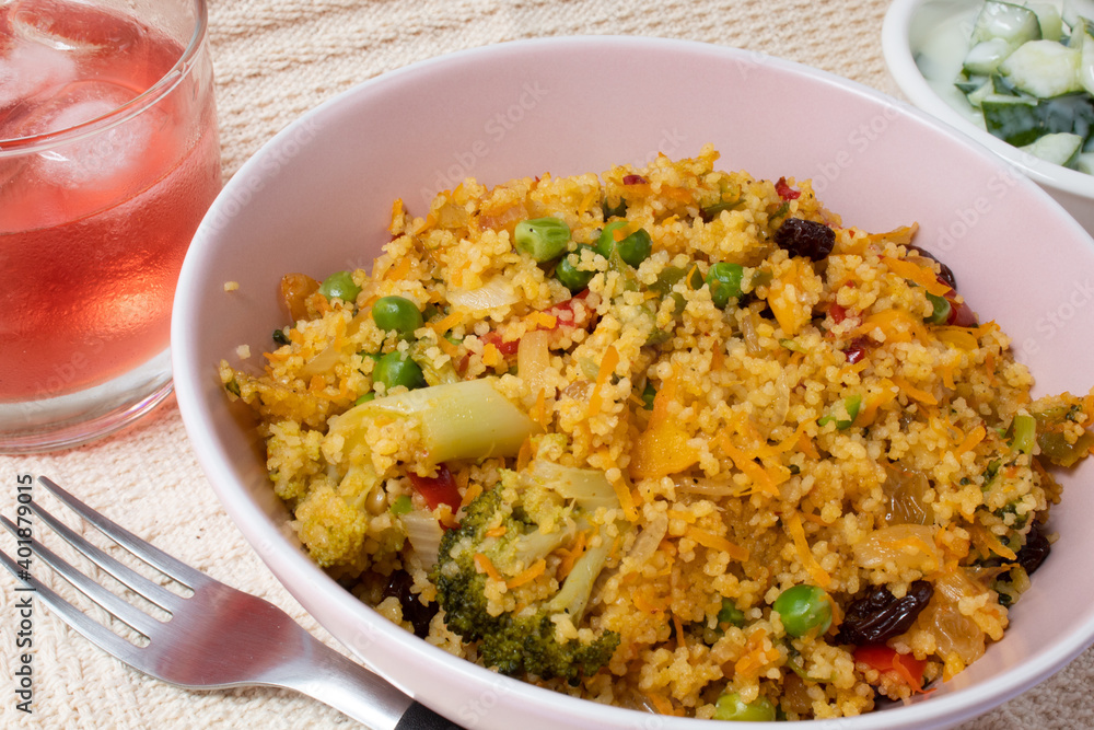 Bowl with Moroccan couscous accompanied by red fruit drink Bowl with Moroccan couscous accompanied by red fruit drink