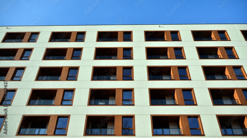 Facade of new apartment building. Glass balcony and clean look of modern architecture building with blue sky background. Facade of new apartment building. Glass balcony and clean look of modern architecture building with blue sky background.