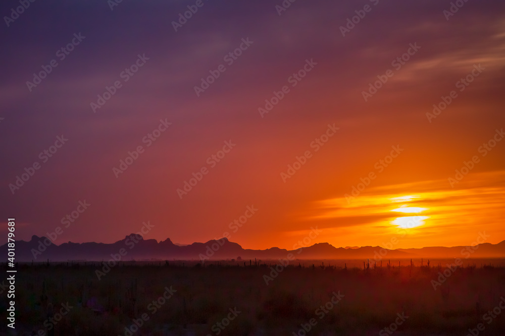 Sunset casts an orange glow over the Sonoran Desert near Pichacho Peak State Park, Arizona.