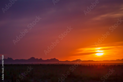 Sunset casts an orange glow over the Sonoran Desert near Pichacho Peak State Park  Arizona.