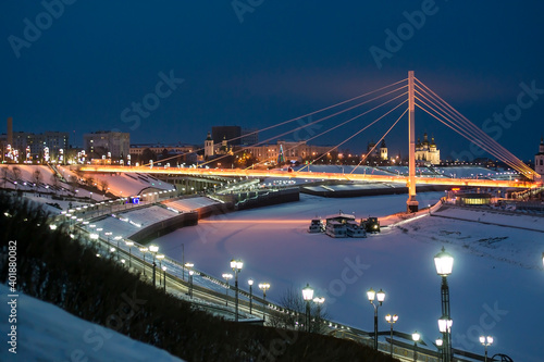 Pedestrian bridge on the embankment in Tyumen, Russia, at night, in winter