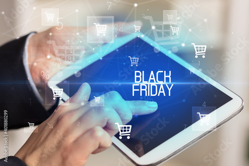 Young person makes a purchase through online shopping application with BLACK FRIDAY inscription