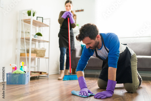 Happy woman doing house chores with partner