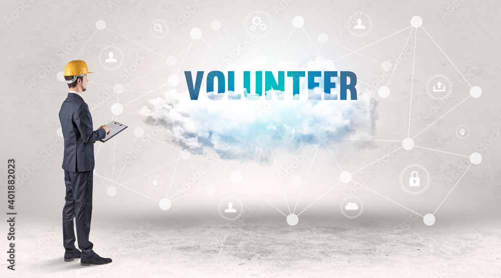 Engineer working on a social media concept with VOLUNTEER inscription Engineer working on a social media concept with VOLUNTEER inscription