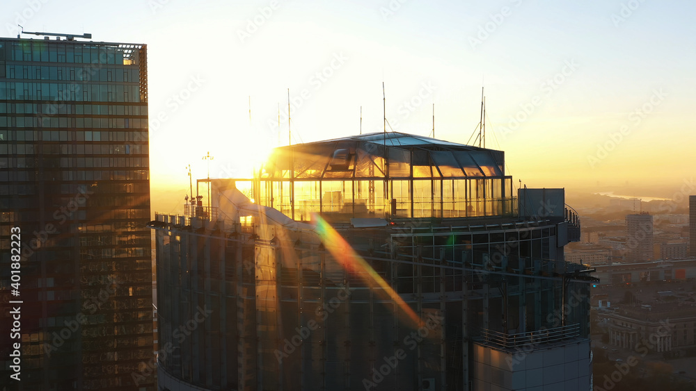 Warsaw, Poland 01.11.2020 Golden sunrise over the Warsaw office tower Spektrum tower and club The View. Aerial. High quality photo