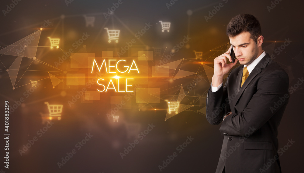 Businessman with shopping cart icons and MEGA SALE inscription, online shopping concept Businessman with shopping cart icons and MEGA SALE inscription, online shopping concept