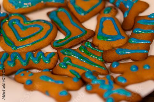 A selective focus shot of cute decorated Christmas gingerbread cookies photo