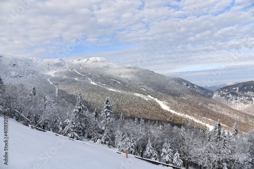 Stowe Ski Resort in Vermont, view to the Mansfield mountain slopes, December fresh snow on trees early season in VT, panoramic hi-resolution image