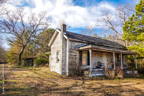 A landscape of an abandoned old house in North Carolina USA on a farm in HDR.