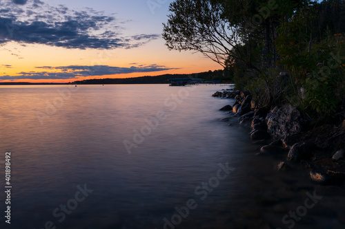 Sunset looking along Torch lake shoreline on a summer night.