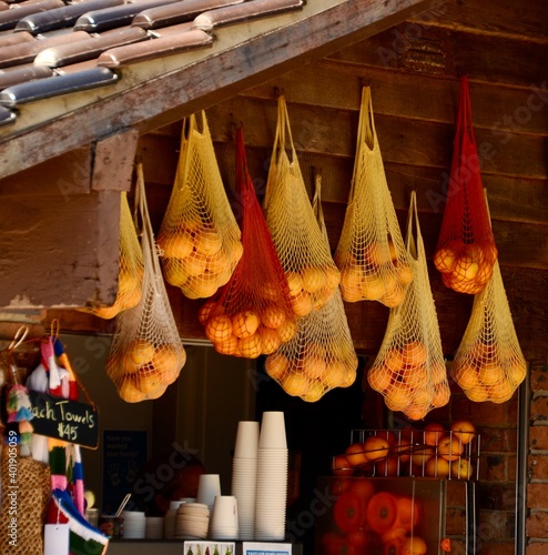 String bags containing oranges hanging from the ceiling of a beachside cafe at Camp Cove, Watstons Bay, Sydney, Australia photo