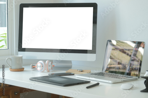 Modern workspace with computer with blank screen and equipment on white table.Blank screen for your information. 