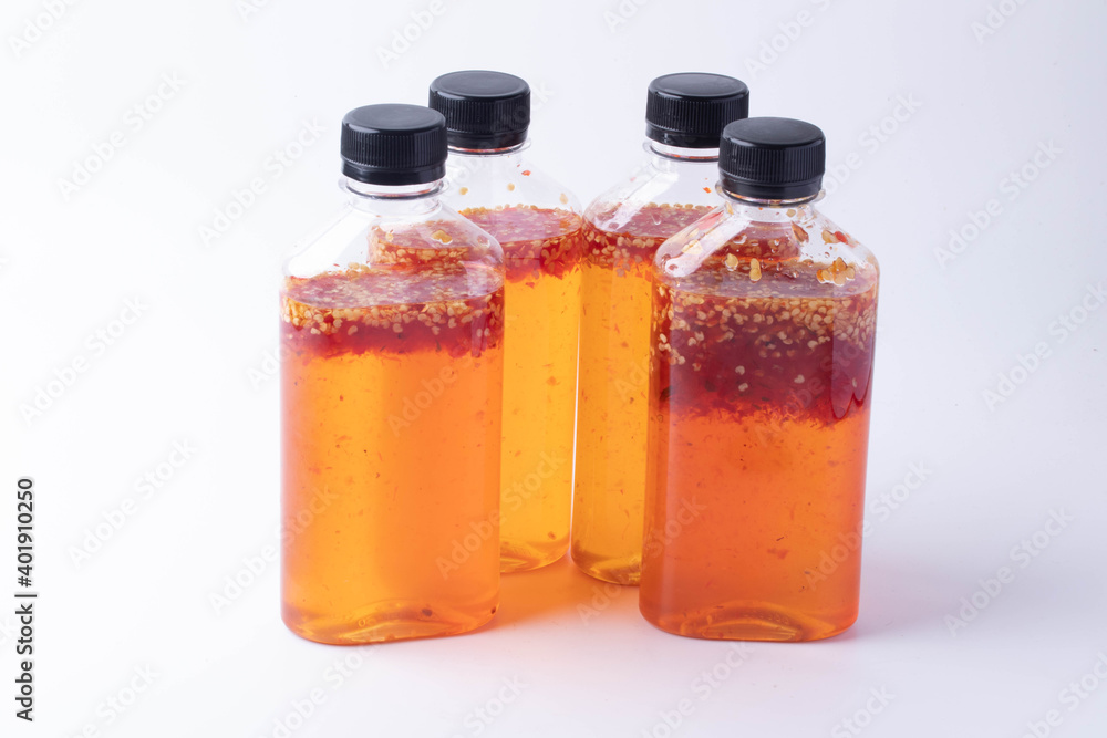 Chicken dipping sauce in a bottle made from sweet hot chili on white background. Chicken dipping sauce in a bottle made from sweet hot chili on white background.