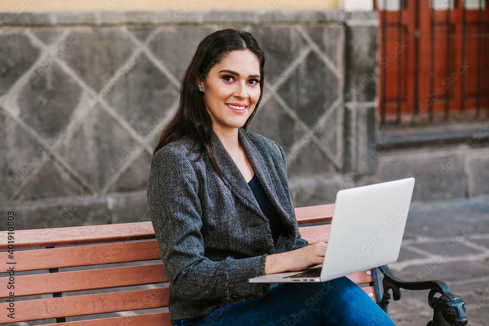 latin woman working with her laptop and coffee in a colonial city in Latin America latin woman working with her laptop and coffee in a colonial city in Latin America