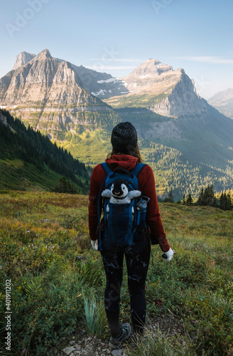 Young adventurer and her travel companion in the mountains