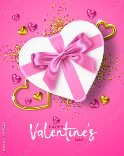 Happy Valentine's Day holiday. Romantic composition of a white gift box in the shape of heart with pink ribbon bow, gold jewelry hearts and confetti around on pink background. For design of greeting c