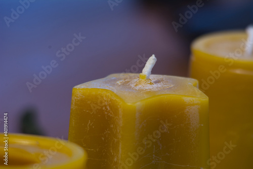 A selective focus closeup of unlighted yellow candles photo