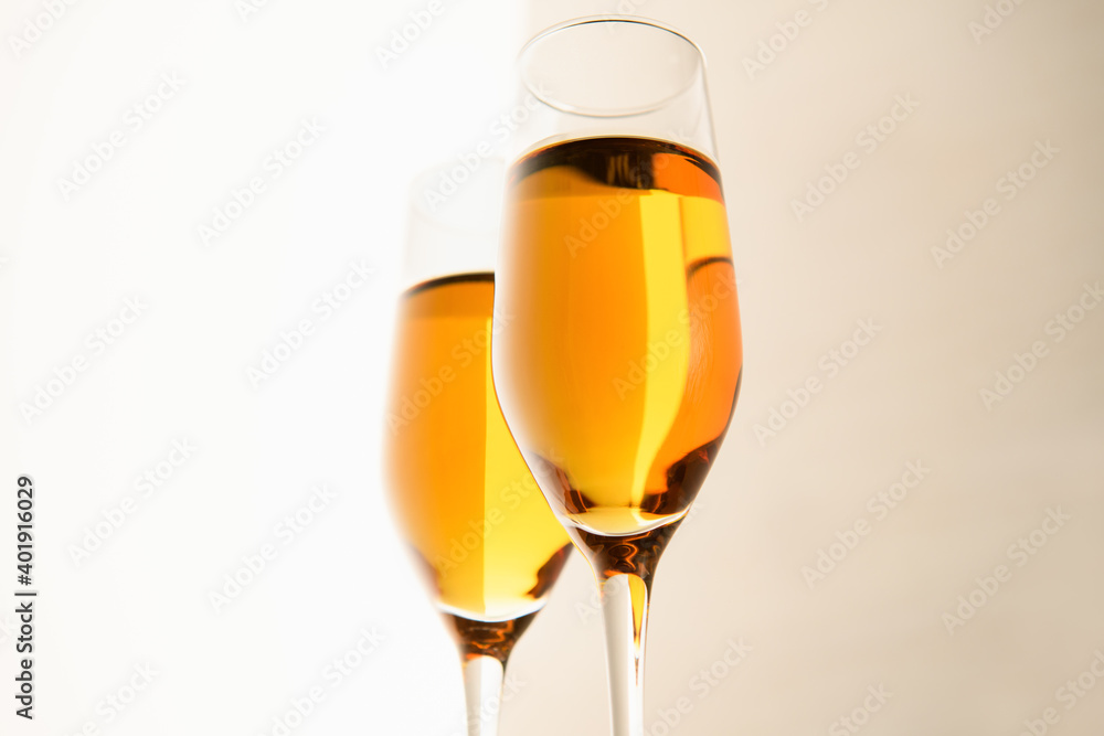 Two glasses of champagne, wine on a gray background. Alcoholic drink: champagne, beer, white wine. New year and Christmas background. Valentine's Day Two glasses of champagne, wine on a gray background. Alcoholic drink: champagne, beer, white wine. New year and Christmas background. Valentine's Day