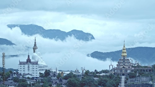 mist are moving around beautiful golden pavilion and the fammous 5 statues buddha of Wat Phachonkeaw.  photo