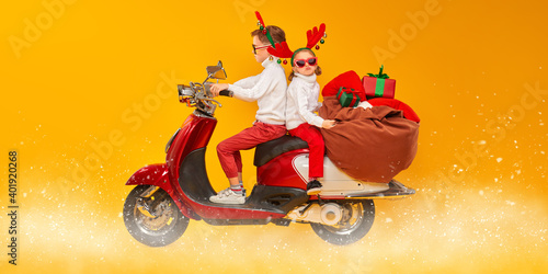 two kids on a scooter