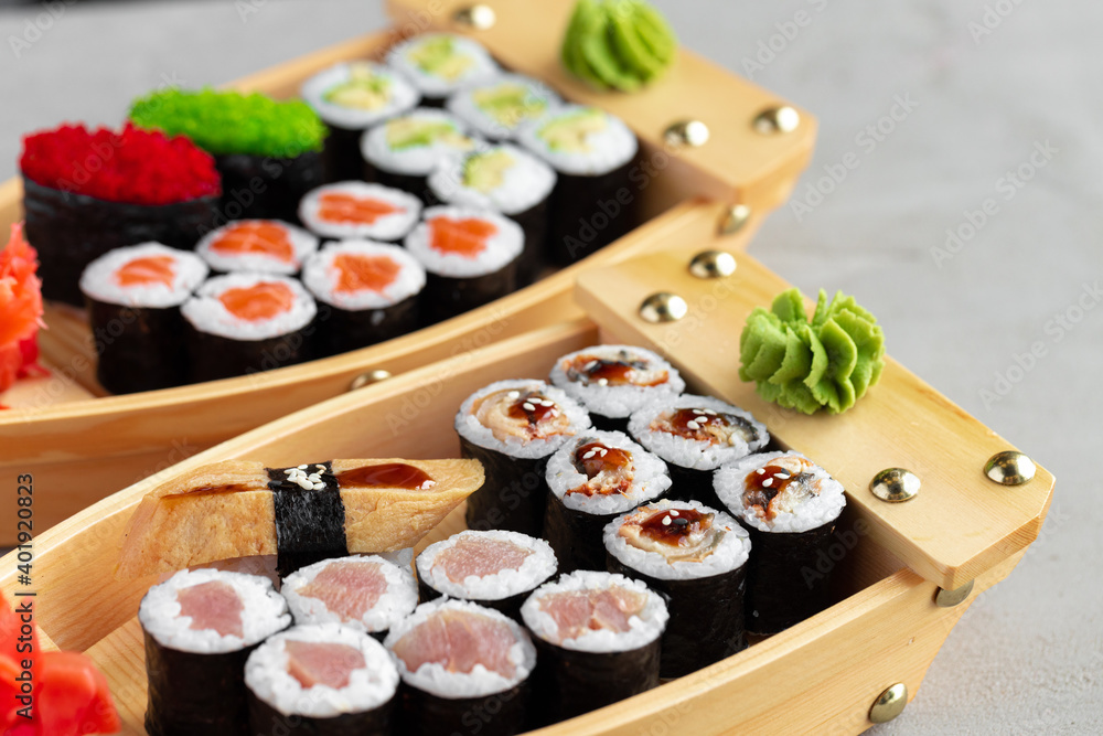 Set of maki sushi on wooden boat tray Set of maki sushi on wooden boat tray