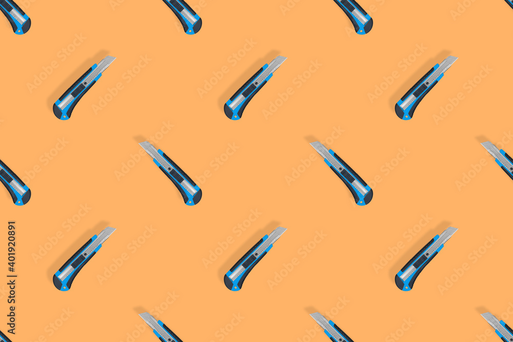 Seamless pattern of stationery knives on an orange background. Seamless pattern of stationery knives on an orange background.