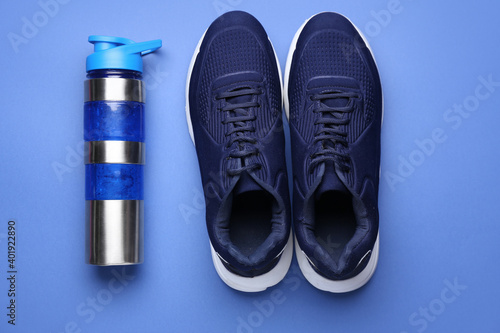 Wallpaper Mural Sportive shoes and bottle of water on color background Torontodigital.ca