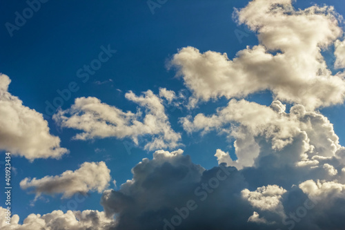 Lush white clouds against blue sunny sky © dashabelozerova