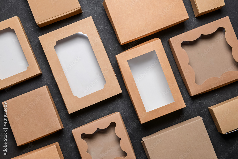 Fototapeta premium Set of blank cardboard boxes on dark background