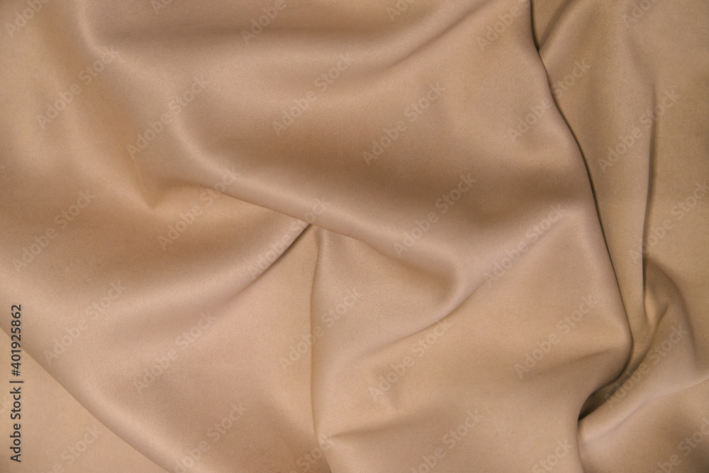 Abstract background of luxury fabric.Folds in waves of silk fabric. The texture of the satin material.