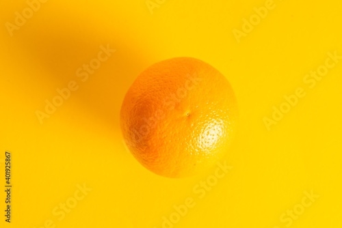 Juicy orange on yellow background