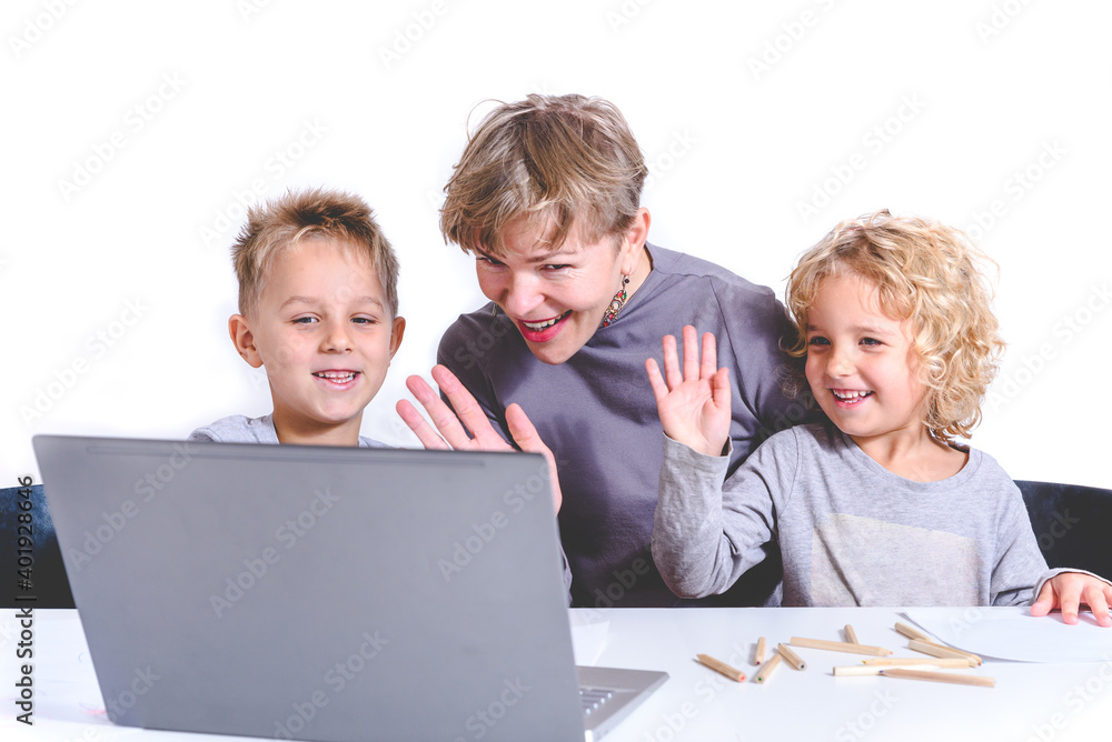 family of woman and two children keeping a video call and waving their hands family of woman and two children keeping a video call and waving their hands