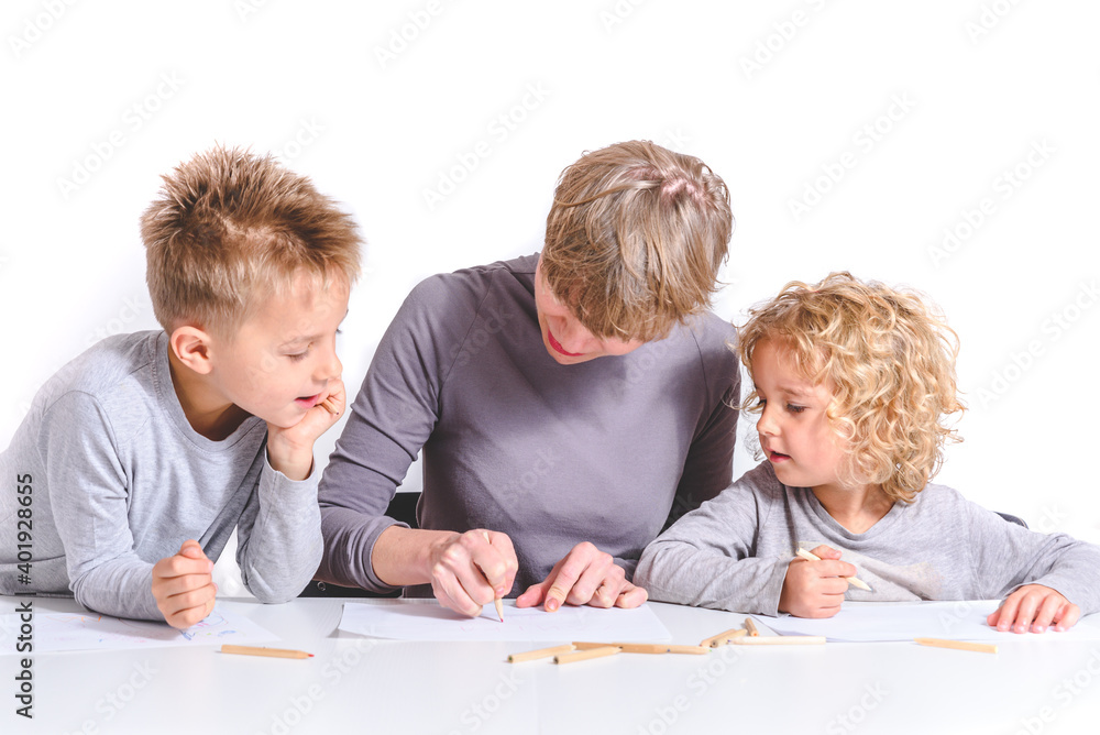 caucasian young blond mother teaching children to write at home caucasian young blond mother teaching children to write at home