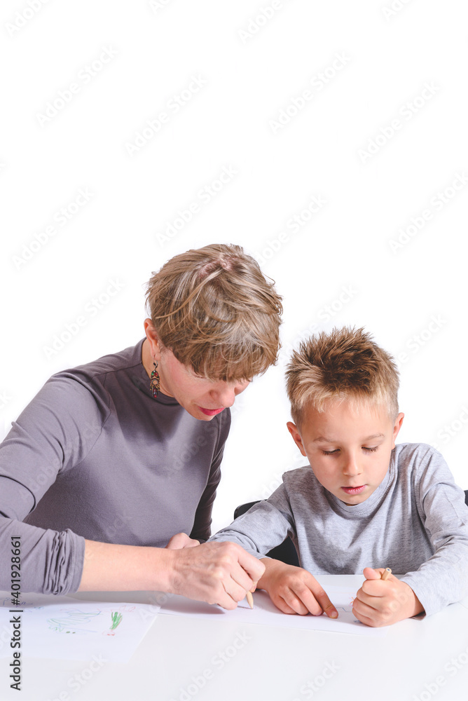 caucasian mother and child drawing together on a white desk with white background