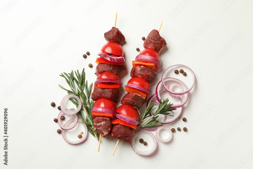 Raw shish kebab, herb and spices on white background