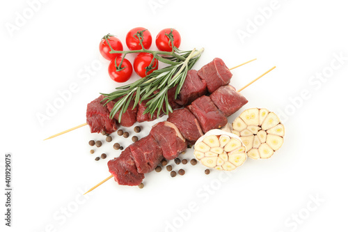 Skewers with raw meat and vegetables isolated on white background