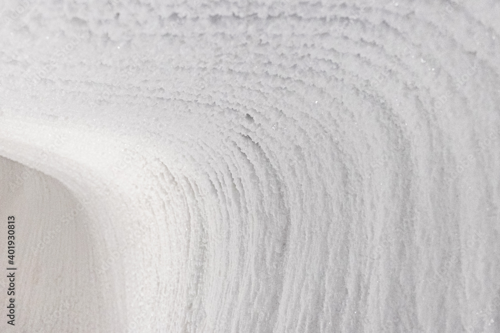 White embossed walls of ice and snow in a cave. Abstract textured natural background. White embossed walls of ice and snow in a cave. Abstract textured natural background.