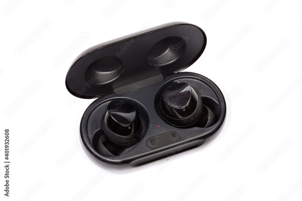Black wireless earphones in wireless charging case on white background Black wireless earphones in wireless charging case on white background