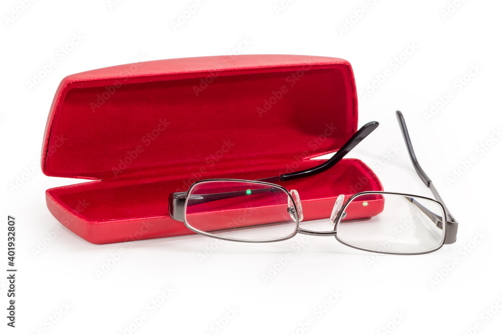 Modern eyeglasses in metal gray rim against red spectacle-case Modern eyeglasses in metal gray rim against red spectacle-case