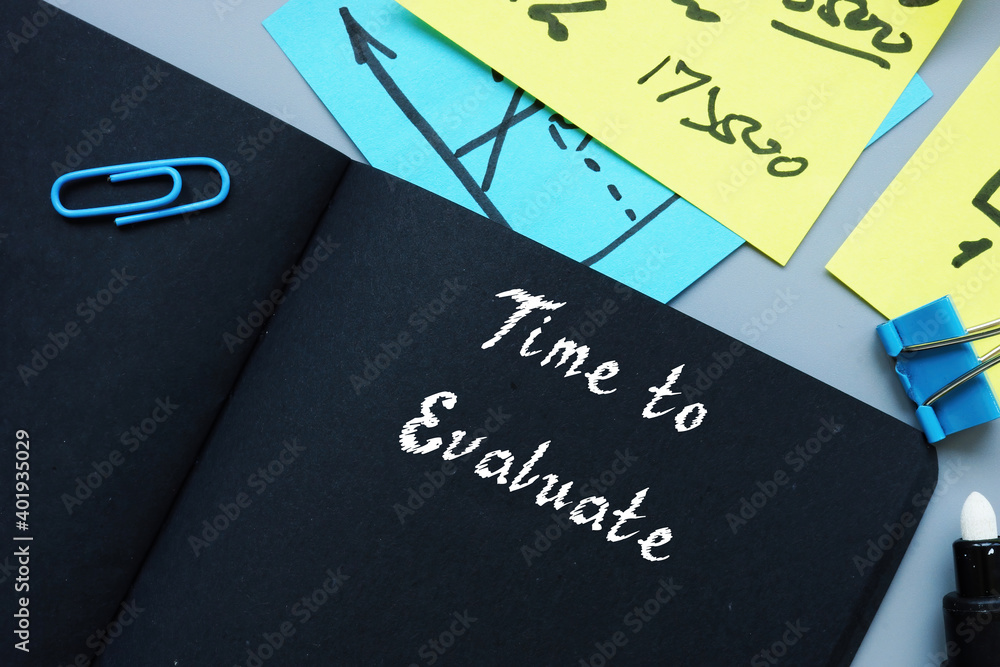 Business concept about Time to Evaluate with phrase on the piece of paper. Business concept about Time to Evaluate with phrase on the piece of paper.